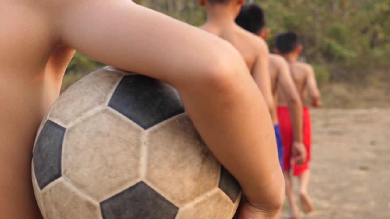 Children Playing Soccer in Rural Area