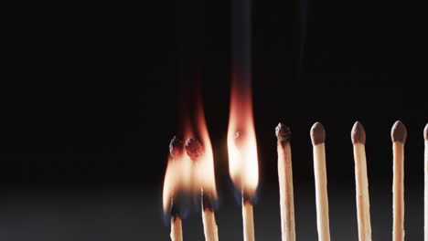 Video of matches with yellow fire flame and copy space on black background