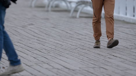 person in joggers and sneakers gracefully strolling along a rustic pier