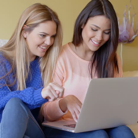 Two-happy-young-women-browsing-the-internet