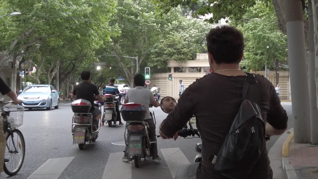 Electric scooter in traffic. Shanghai, China