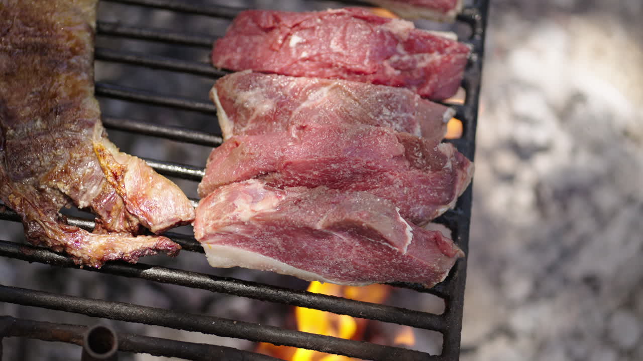 Close-Up of Juicy Picanha Slices Grilling on Open Fire at Traditional Argentine BBQ.