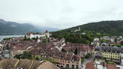 City-Buildings,-Castle,-and-Lake-of-Annecy,-France---Aerial-Drone-Flight