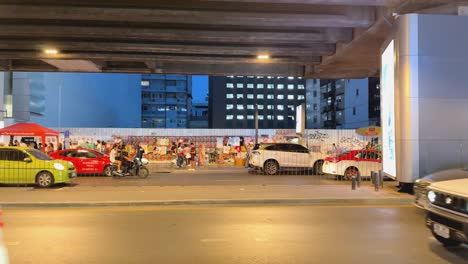 city street scene at night under an overpass