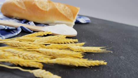 bread loaf with wheat grains and flour