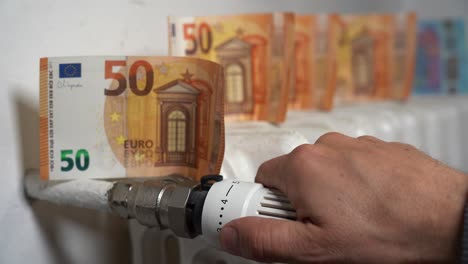 europe, italy , increase in the cost of bill for  gas and electricity causes increased price for the procurement of raw materials, money euro banknote and domestic heating radiator