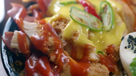 chicken and egg bowl with mayo and chili sauce