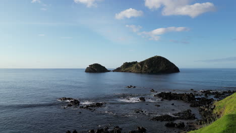 Flying-towards-the-small-island-of-Vila-Franca,-and-old-volcanic-crater-on-the-island-of-the-Azores-in-Sao-Miguel