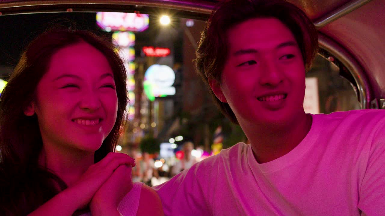 Couple enjoying a night out in a tuk-tuk