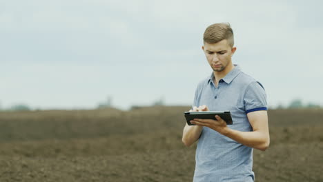 A-Young-Successful-Farmer-Is-Working-In-The-Field-1