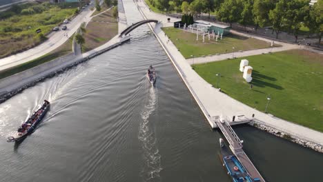 canoeing in water canal near city of aveiro, aerial orbit view