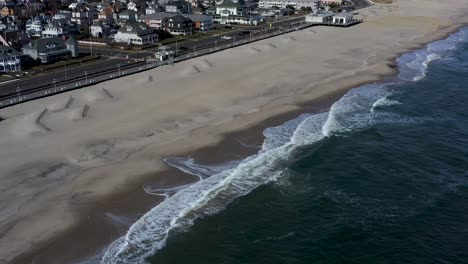 aerial footage coming into a quaint beach town from the ocean