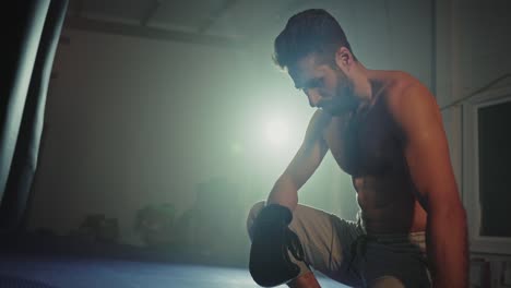 tired boxer resting in gym