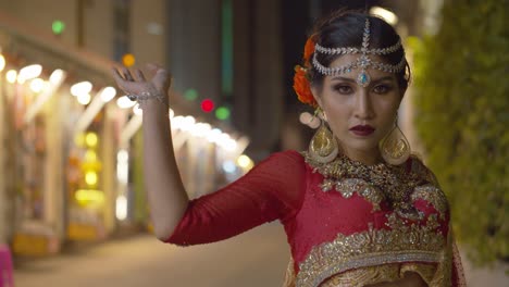 Beautifully-stunning-woman-wearing-traditional-Indian-Sari-poses-for-her-glamour-wedding-portraits-under-the-night-lights-of-the-city