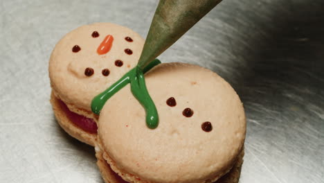 decorating snowman macarons