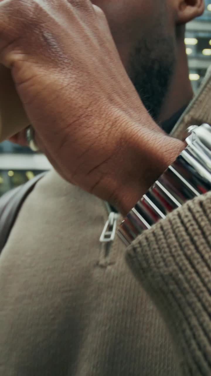 Man using phone and drinking coffee in the city