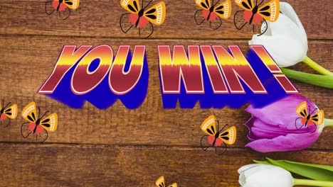 animation of you win text in red and blue letters over butterflies and tulips on wooden background