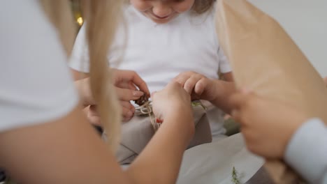 family opening the christmas presents in bed