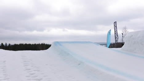 Slowmotion-Shot-of-a-Girl-Snowboarder-doing-Tricks-on-a-Jump