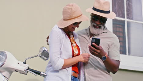 Senior couple on vacation with a scooter