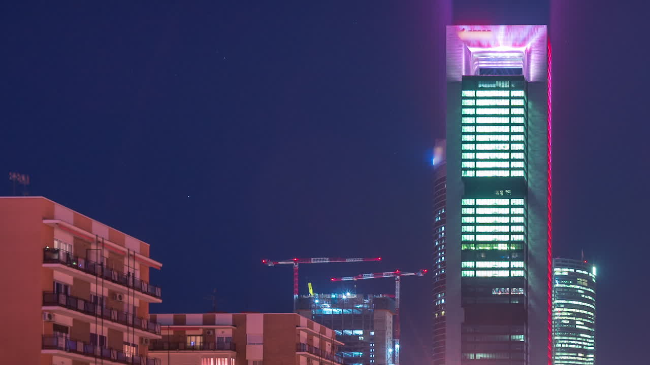 timelapse nocturno de la zona empresarial de cuatro torres en madrid, españa