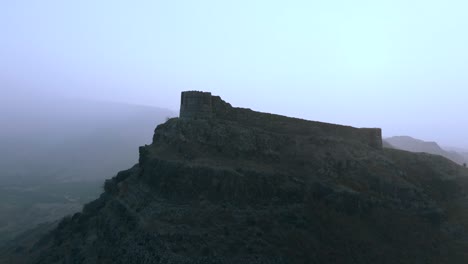 forward aerial view of ranikot fort in sindh on a foggy day in pakistan