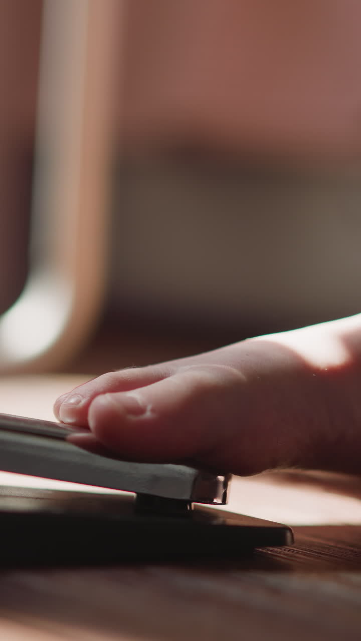 Child bare foot presses pedal of electronic piano. Girl musician changes settings of sound of notes during performance of musical composition closeup