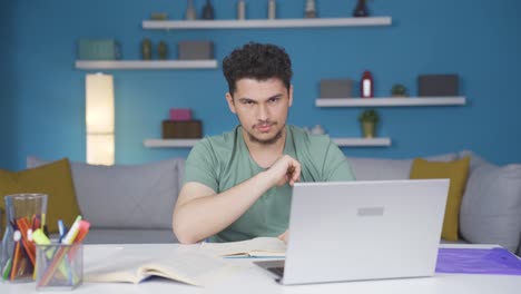 Male-student-looking-at-camera-with-negative-and-negative-gesture.