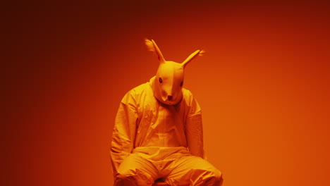 person in rabbit mask and hazmat suit