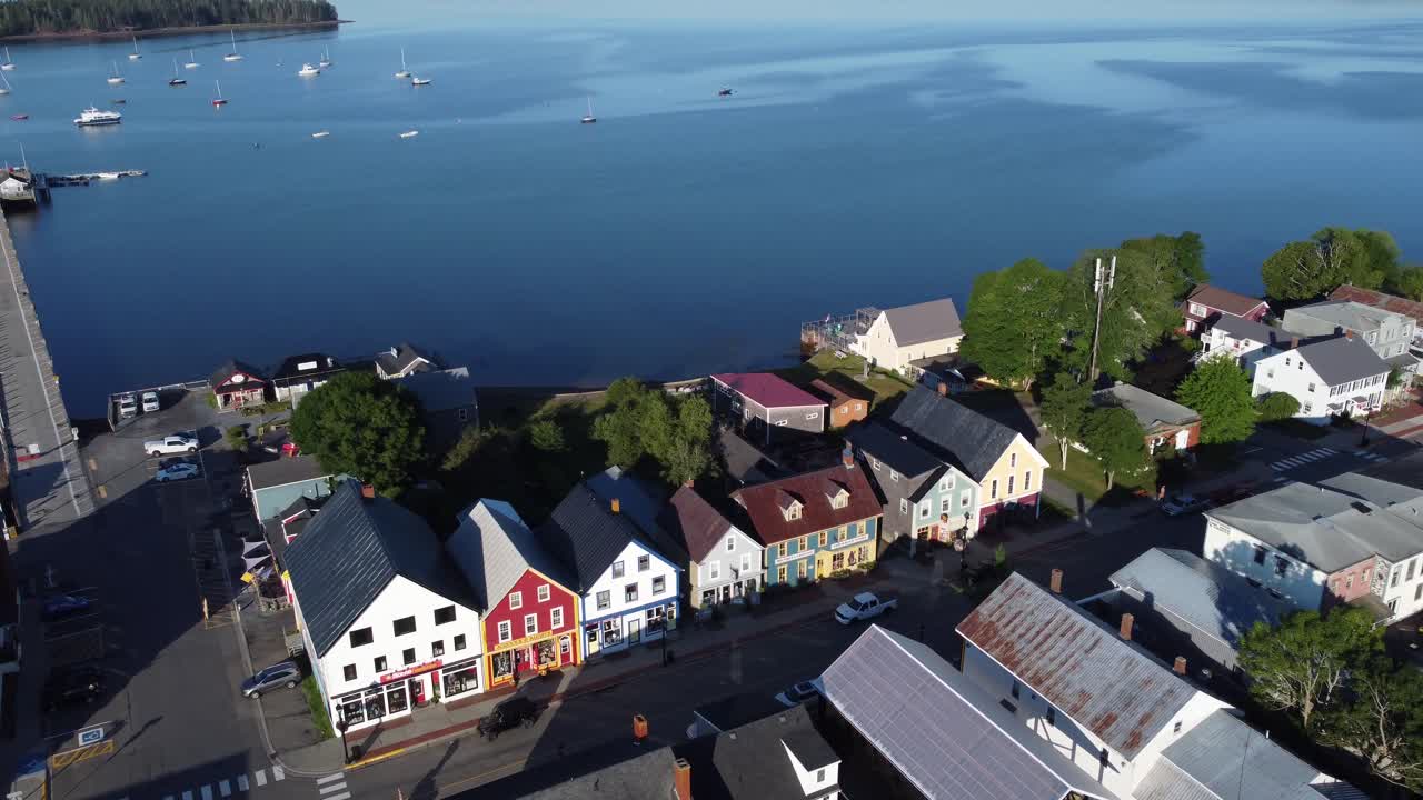 Aerial drone over in St-Andrews by the sea on a clear sunny morning revealing the pier