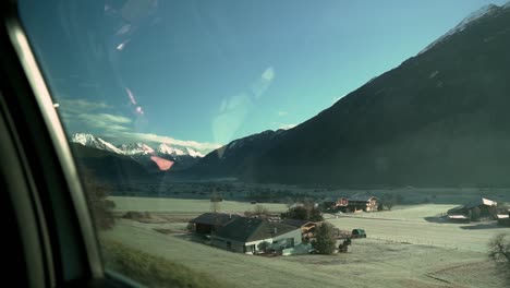 slow motion footage through the car side window while driving in the swiss alps