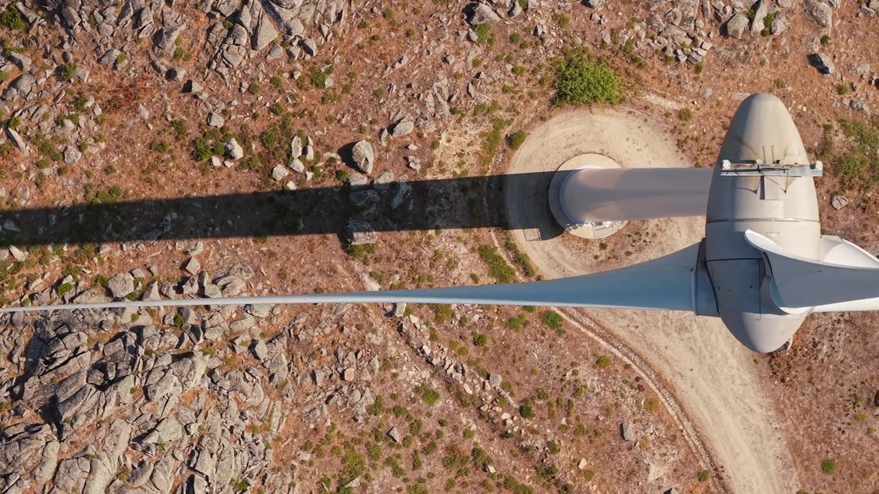 Overhead drone flight following a wind turbine shadow