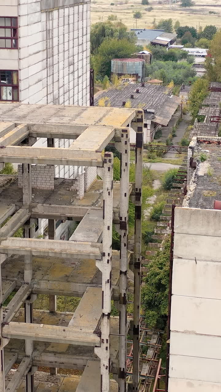 Industrial destroyed city buildings. Abandoned ruined factory building architecture. Vertical video