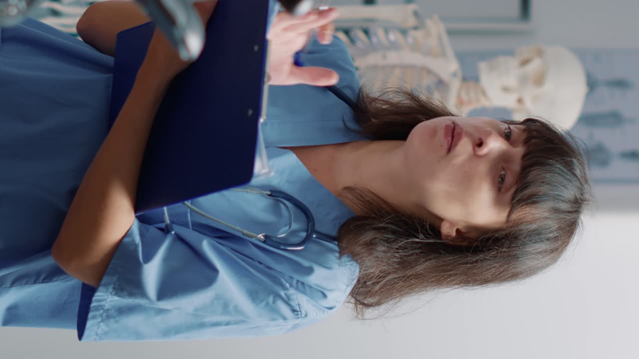 Medical assistant supporting senior patient doing physical exercise