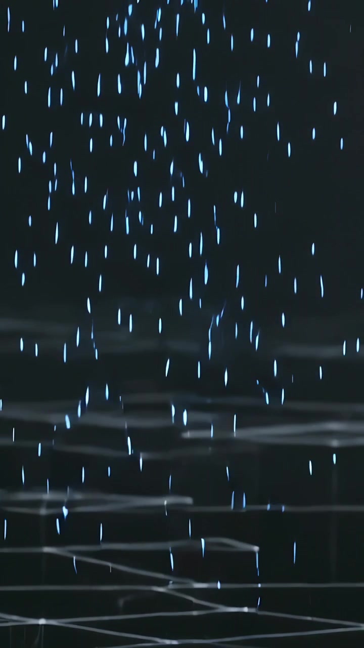 Vertical video: Rising stream pushing cyan drops, forming lit pool and column on grid in dark void