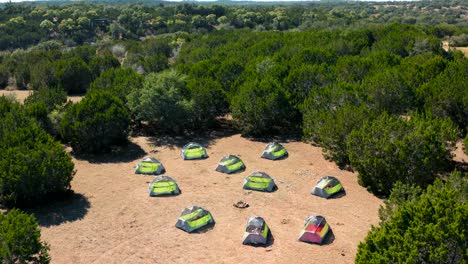 secluded campsite rising up with tents and firepit