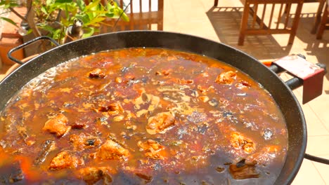 close up shot of traditional paella rice popular been cooked on a gas stove in the spanish town of valencia