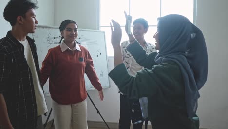 asian multiethnic students learn singing together and clapping hands at classroom