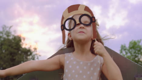 little girl pretends to fly with