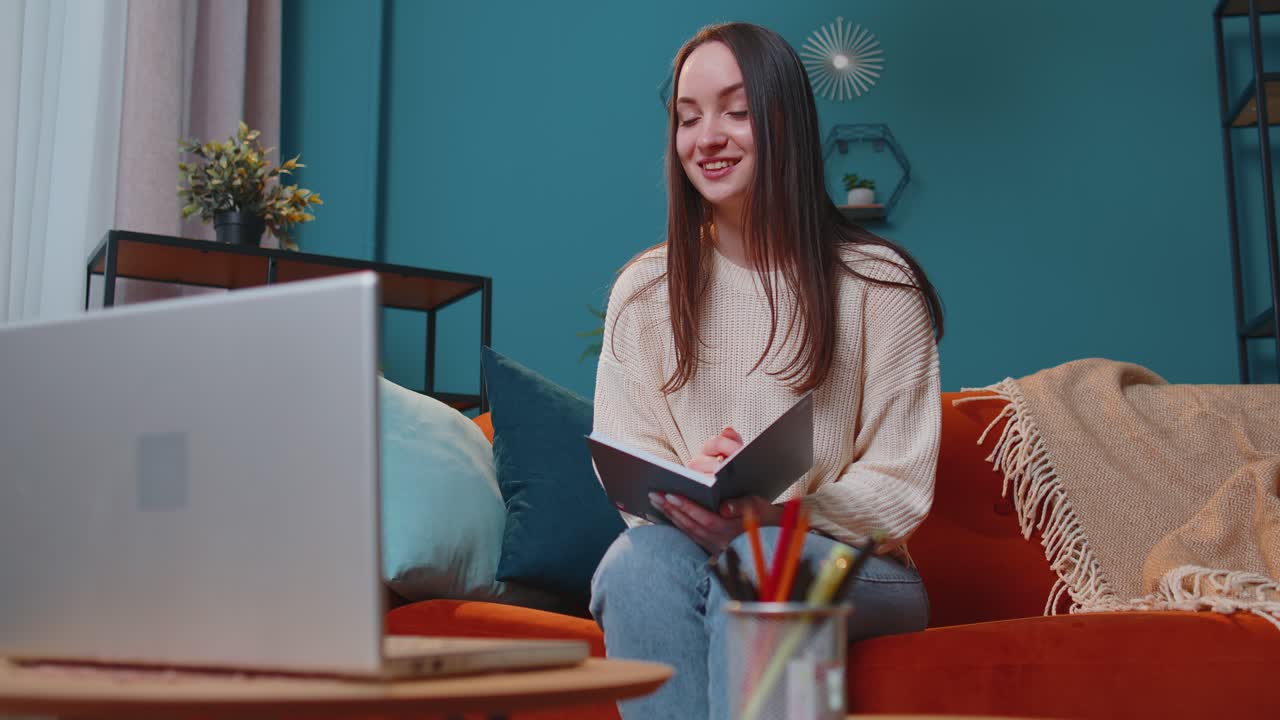 Adult girl student study at home on laptop computer making conference video call talking to webcam
