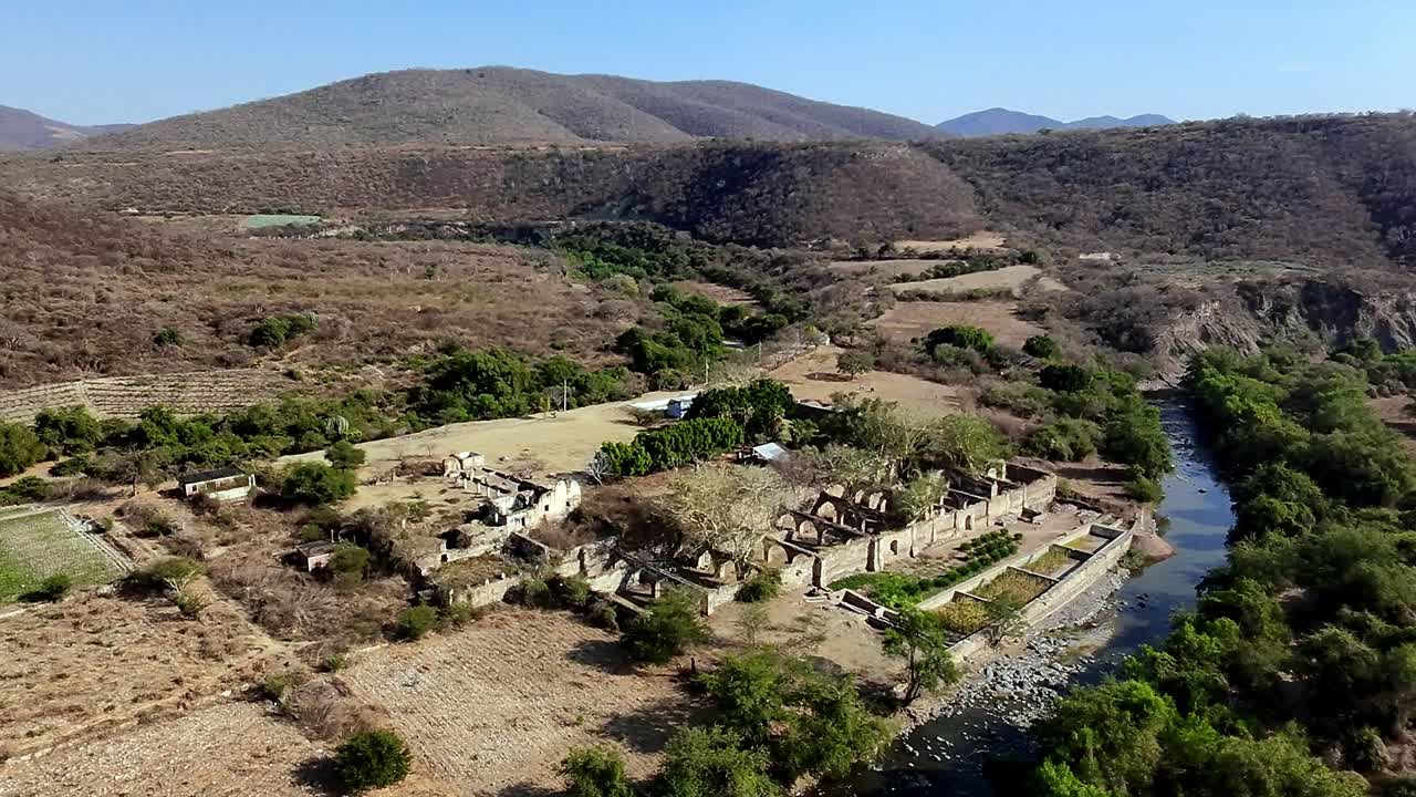 View from above of the entire landscape of the hacienda ruins with the river on its side
