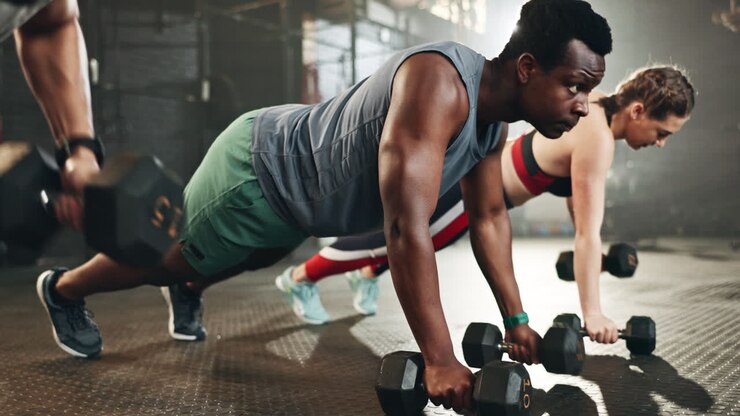 Gym group, dumbbell and rowing exercise for power