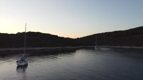 Revealing-drone-shot-over-an-mediterranean-island-of-Croatia-with-stunning-colors-as-sun-goes-down-in-the-distance