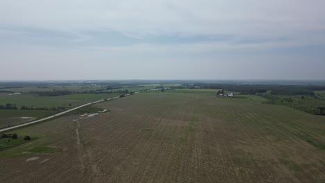 Agricultural-Fields-Under-Cloudy-Sky---aerial-drone-shot