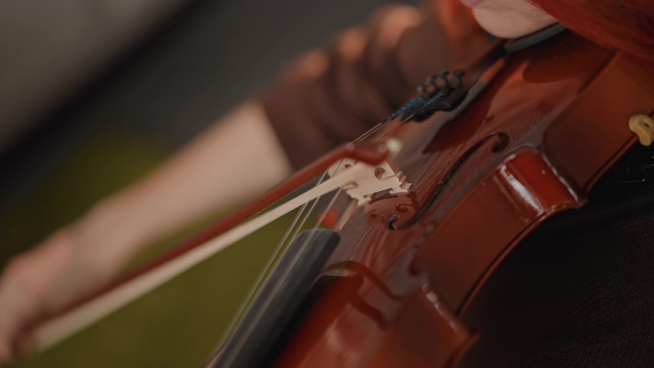 String technique closeup. Violin bowing and finger positioning. Close view of violin string and bowing detail. Comprehensive closeup capturing technique and craftsmanship of violin string play