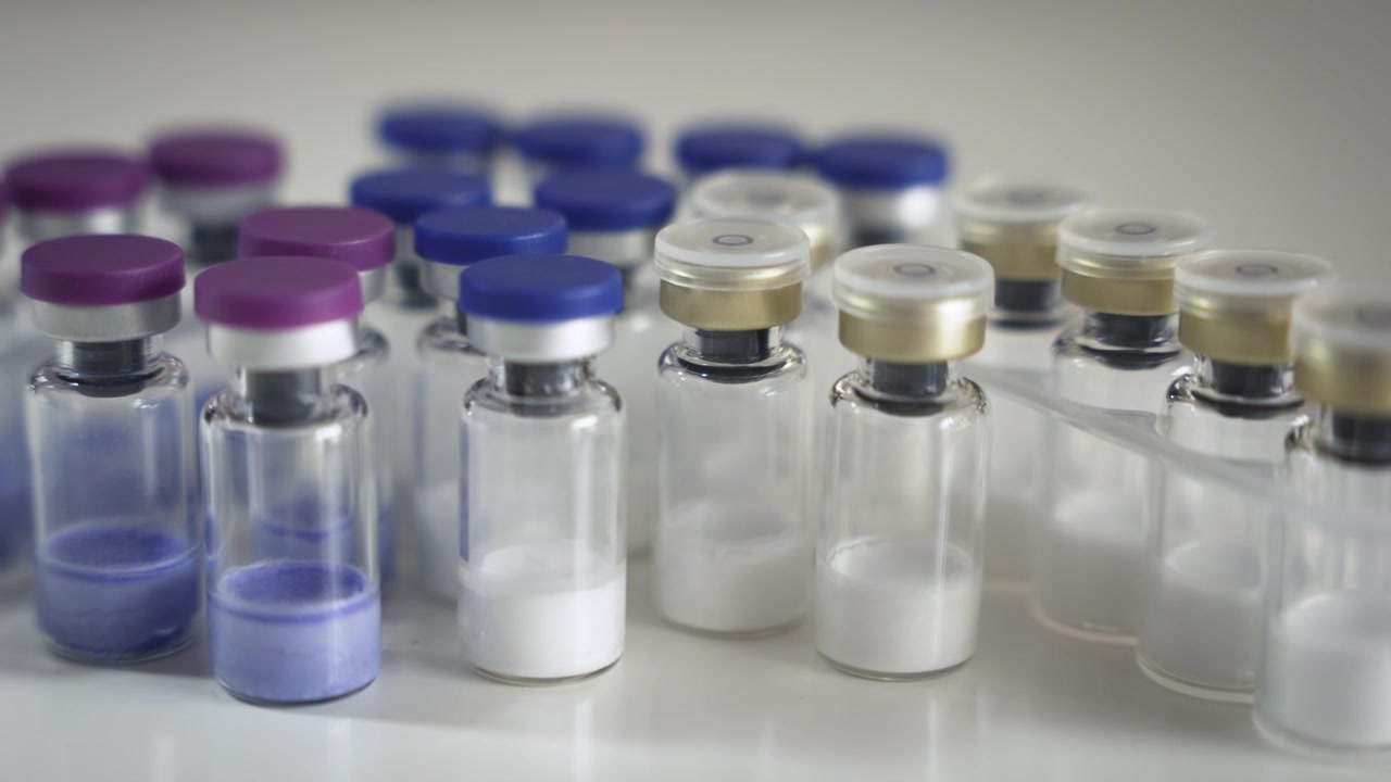 Pan Right Across Multiple Pharmaceutical Vials on Table [Peptide Concept]