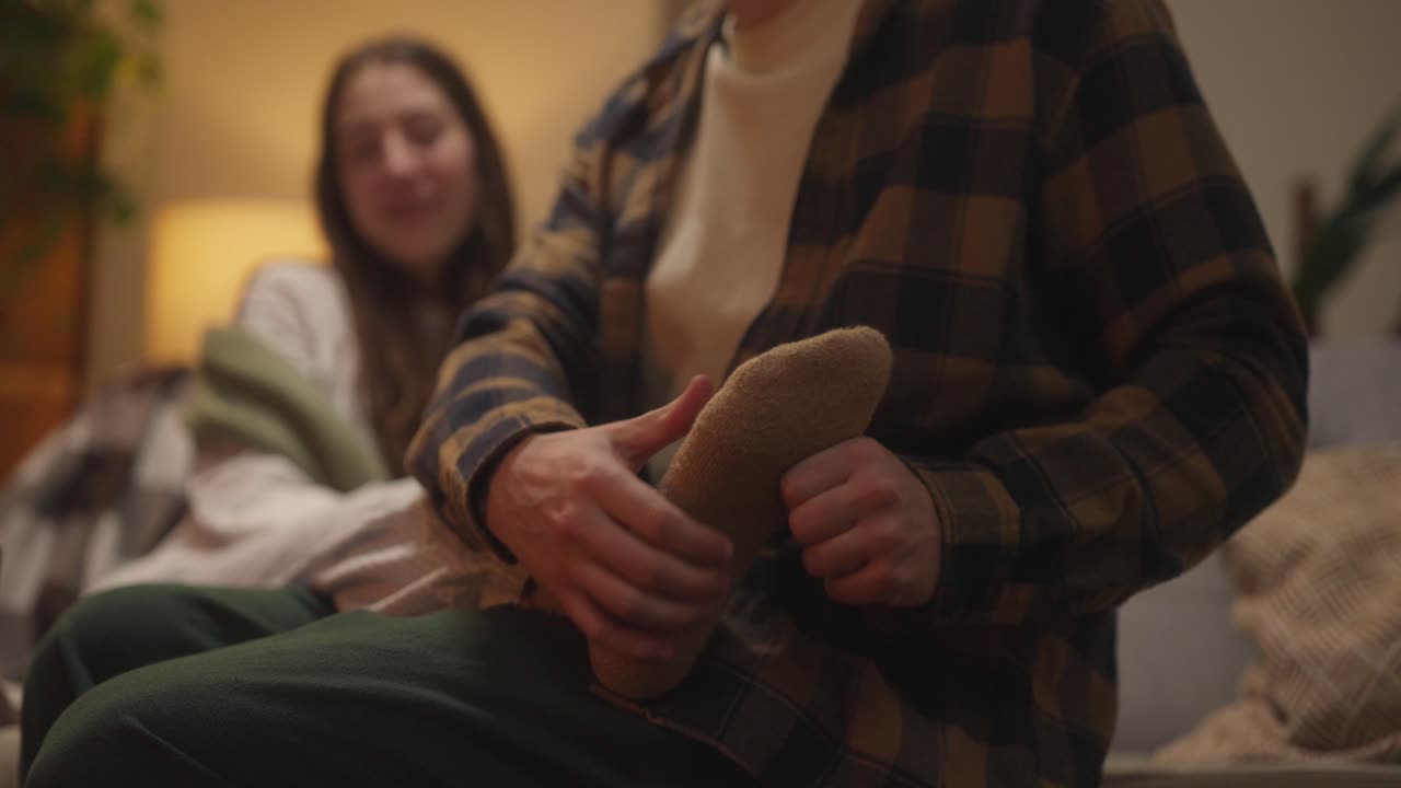 Couple relaxing with foot massage at home