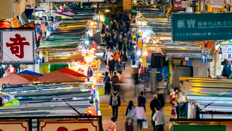 4k timelapse - anonymous people crowd walking on the night market. night life of hong kong city