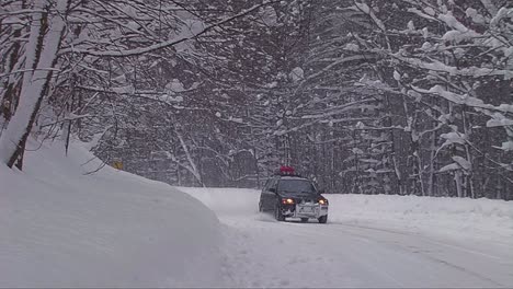 A-car-travels-on-a-snowy-mountain-road-1