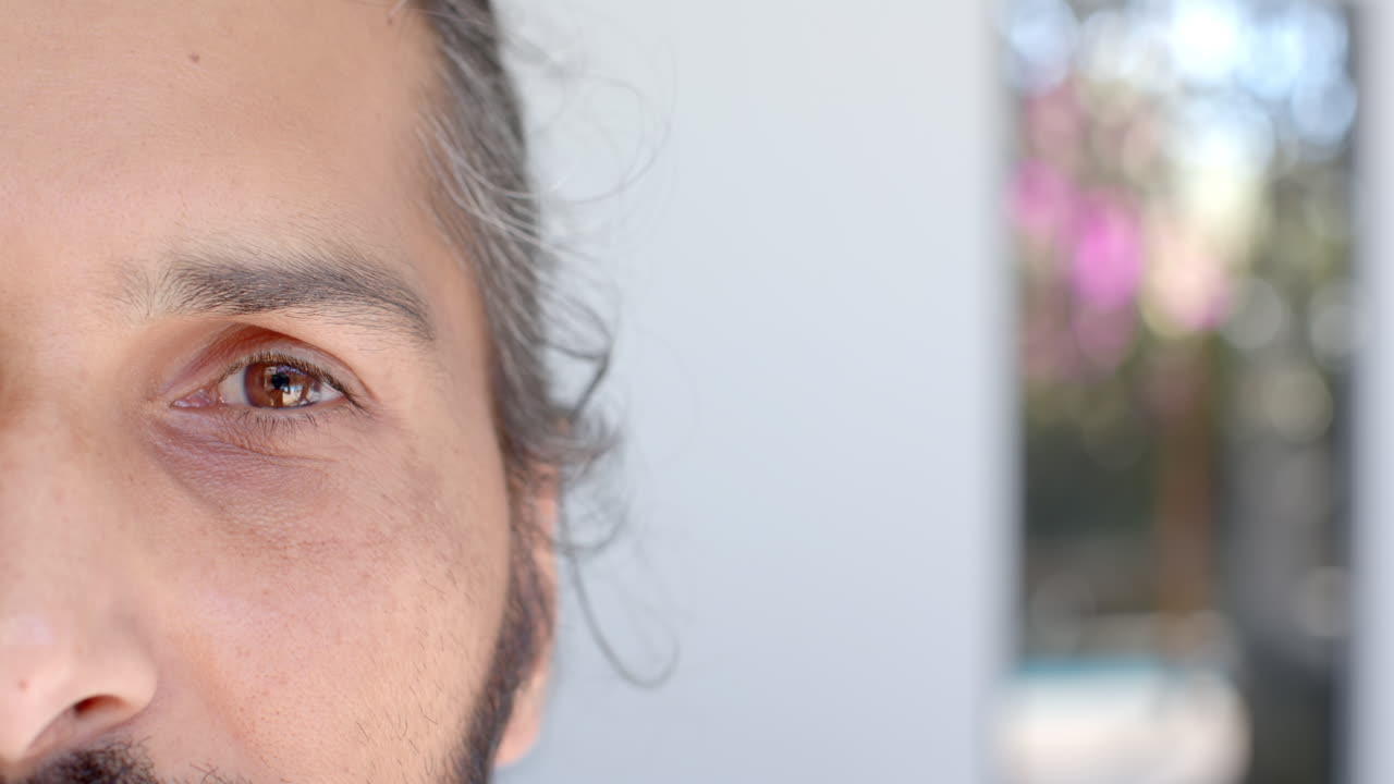 Close-up of Indian male's eye with natural light and soft focus background
